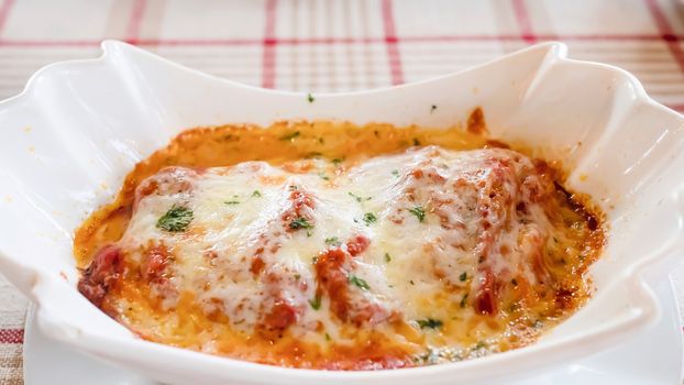 Delicious lasagna recipe - people with famous Italian food concept