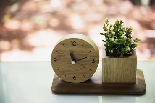 Small wooden clock with decorated flower set - interior home decoration object for background use