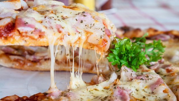 Family lunch eating pizza ham cheese recipe - people with favour italian dish concept