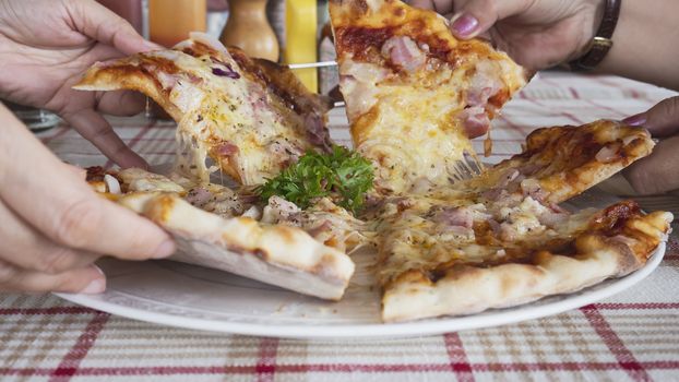 Family lunch eating pizza ham cheese recipe - people with favour italian dish concept