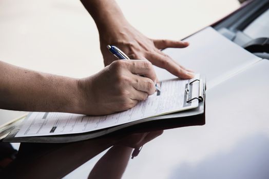 Man working with car maintenance checklist - people with car maintenance concept