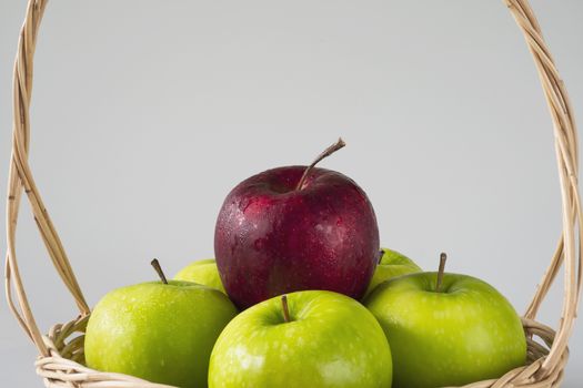 Fresh colorful apple over gray background - clean fresh fruit background concept