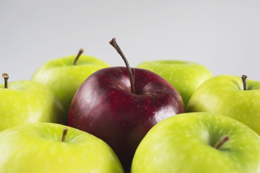 Fresh colorful apple over gray background - clean fresh fruit background concept