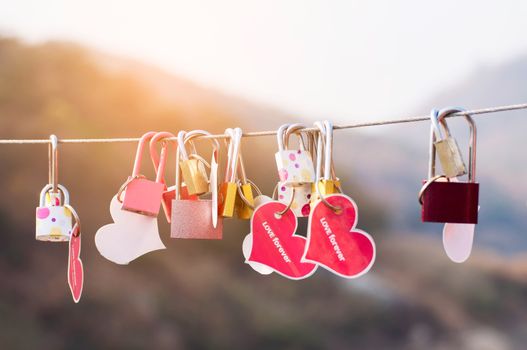 Padlock key with heart symbol of love on bridge - culture of love sign symbol concept