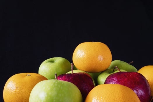 Fresh red green apple and orange over gray black background - fresh fruit background concept