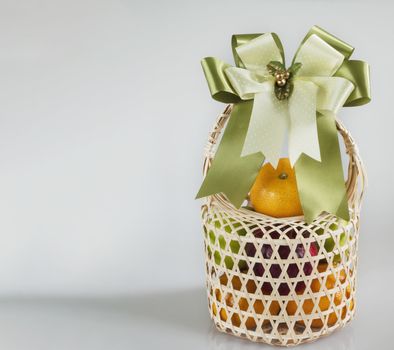 Fresh fruit souvenir in weaved bamboo package over white gray background - fresh fruit gift set for special occasion concept