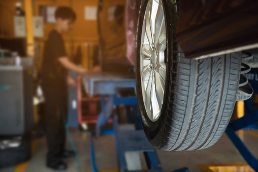 Technician is inflate car tire - car maintenance service transportation safety concept
