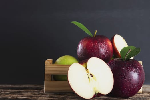 Fresh apple in wooden box over black background - fresh fruit background concept