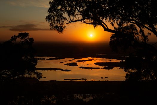 Sunrise lake views through the silhouetted tree tops of Ausralian gum trees