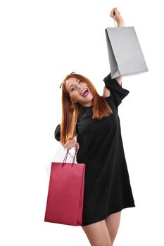 Sale, shopping concept.Portrait of an excited beautiful young woman with shopping bags in both hands, isolated on white background.