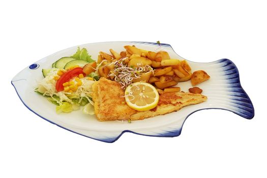 Fried fish with fried potatoes and lemon slices on fish-shaped plate against white background.
