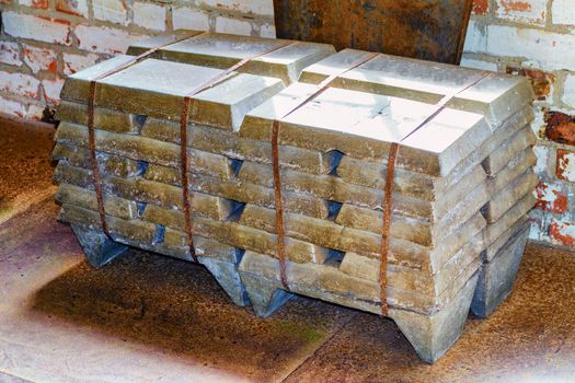 Stack of old raw aluminum ingots in an old foundry