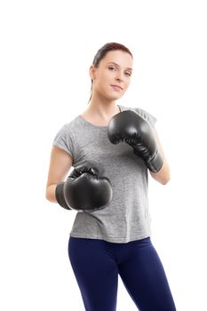 A portrait of a beautiful young woman with boxing gloves in a stance with raised arms, isolated on white background.