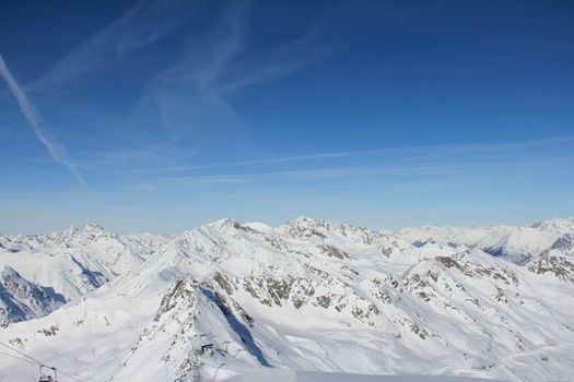 Range of winter mountain peaks at sunny day at Soelden Austria