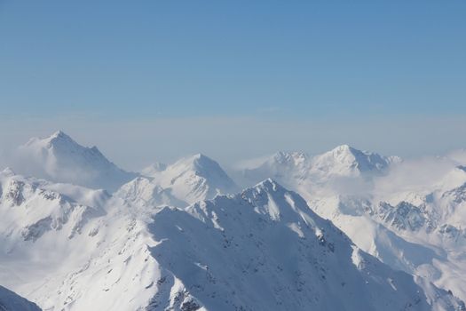 Range of winter mountain peaks at sunny day at Soelden Austria