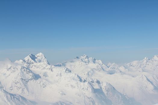 Range of winter mountain peaks at sunny day at Soelden Austria