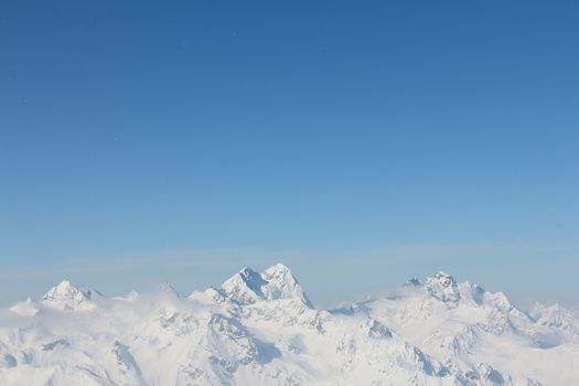 Range of winter mountain peaks at sunny day at Soelden Austria