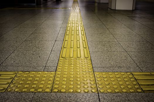 Tactile paving to assist the vision impaired at a train station in Osaka, Japan.