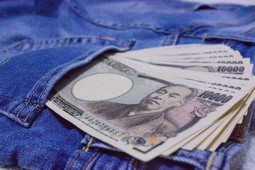 Japanese bank notes in pocket of jeans.