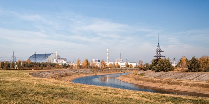 panorama of nuclear power plant with river and forest Chernobyl Ukraine in autumn