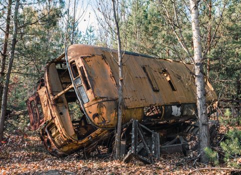 abandoned broken equipment car in the Chernobyl forest Ukraine in autumn