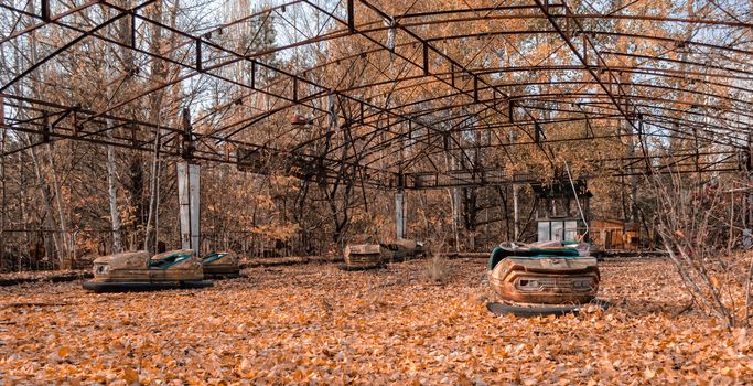 cars in an abandoned amusement park in Chernobyl Ukraine in autumn