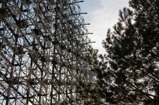 secret army soviet radar and pine tree on a background of blue sky and clouds in Chernobyl Ukraine
