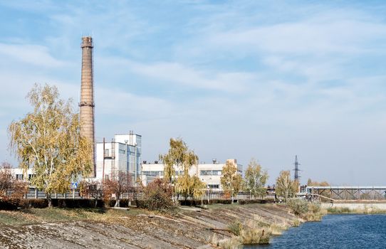 famous place nuclear power plant on the river bank against the blue sky in Chernobyl Ukraine in the afternoon in the fall