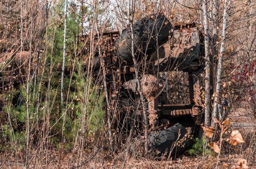 abandoned broken equipment car in the Chernobyl forest Ukraine in autumn