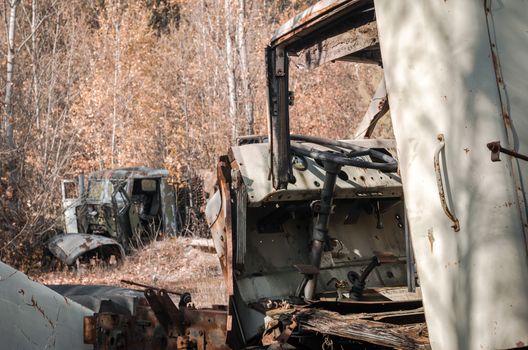 abandoned broken equipment car in the Chernobyl forest Ukraine in autumn