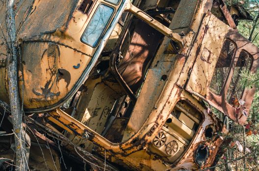 abandoned broken equipment car in the Chernobyl forest Ukraine in autumn
