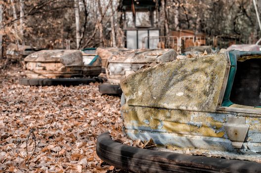 cars and nobody in an abandoned amusement park close up in Chernobyl Ukraine