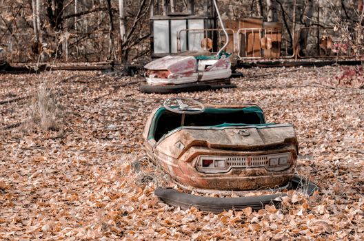 cars and nobody in an abandoned amusement park in Chernobyl Ukraine autumn