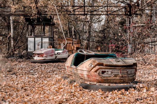 cars and nobody in an abandoned amusement park in Chernobyl Ukraine