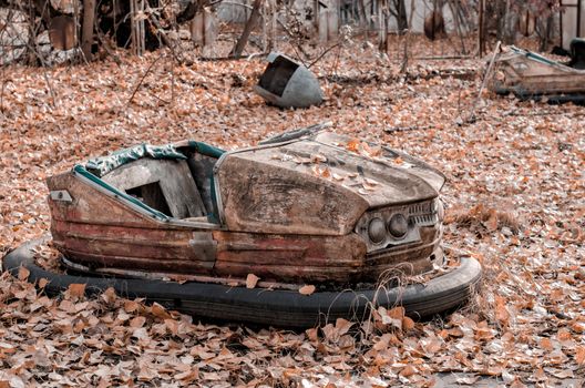 car and nobody in an abandoned amusement park in Chernobyl Ukraine in autumn