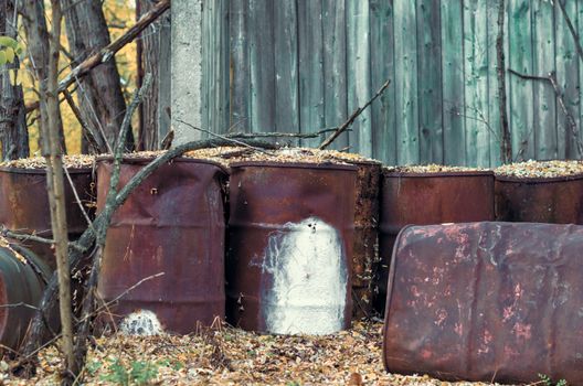 old barrels of chemical waste and chlorine in the forest in Chernobyl Ukraine in autumn