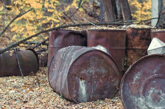 old barrels of chemical waste and chlorine in the forest in Chernobyl Ukraine in autumn close up