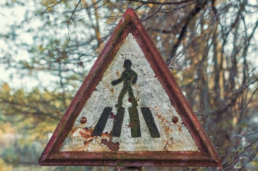 old triangular road sign in Chernobyl Ukraine in autumn closeup