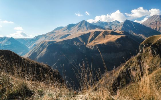 mountain landscape with blue sky and clouds in Georgia in autumn