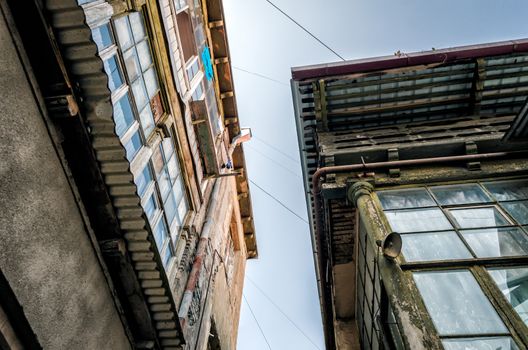 windows and roofs of old houses against the blue sky in the city of Tbilisi Georgia