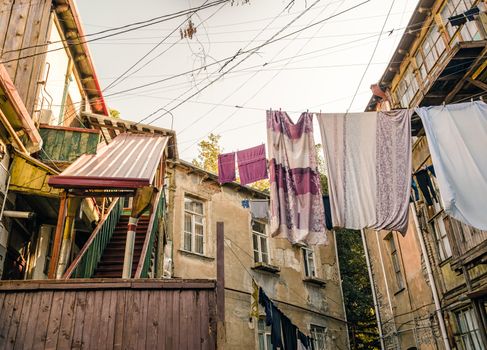 old houses with stairs and balconies with ropes and clothes in Tbilisi Georgia