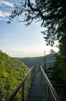 long safe metal bridge in canyon in Georgia in autumn without people