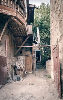 old house with a wooden balcony in a slum in Georgia in autumn