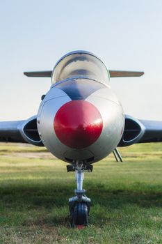 vintage sports plane on grass at the airport closeup on blue sky background