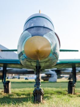 vintage military reconnaissance aircraft at the airport on grass against blue sky background