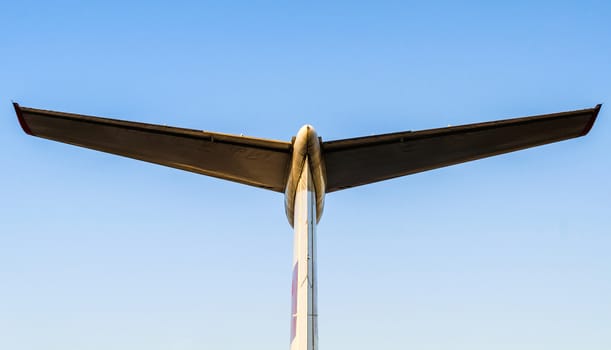 abstract background wings of a large airliner on a blue background isolated