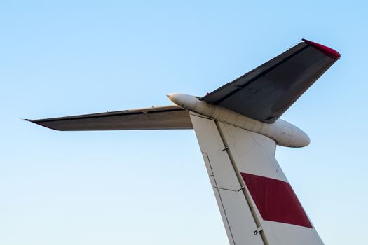 part tail of a soviet airliner close up isolated on a blue sky background