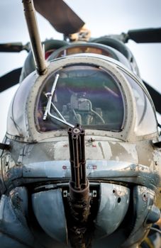 cockpit of a russian army military helicopter with a machine gun closeup