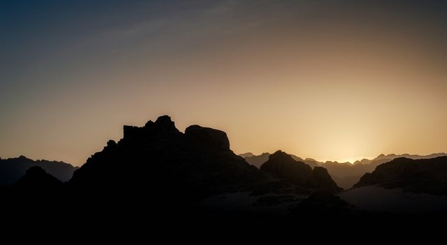 sunset in the mountains with a blue sky and clouds in the desert in Egypt in Sharm El Sheikh