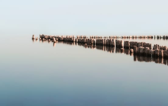 wooden columns in a calm surface of the water